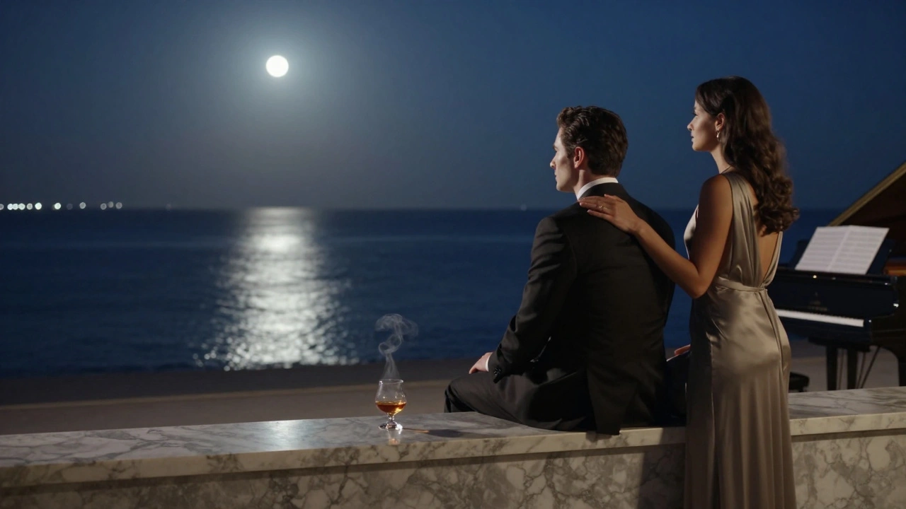 A man and woman sit in quiet contemplation at The Rock Bar, overlooking the moonlit Mediterranean at midnight.