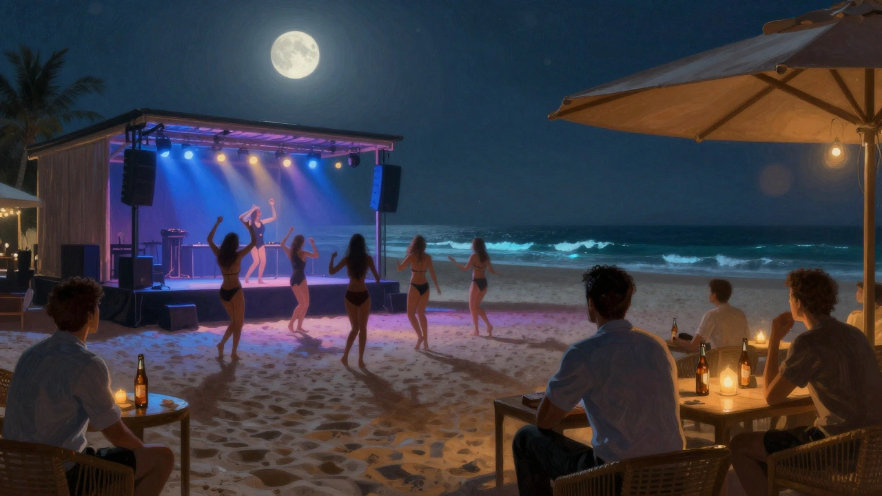 Barefoot dancers under moonlight at an open-air beach club with glowing DJ stage.