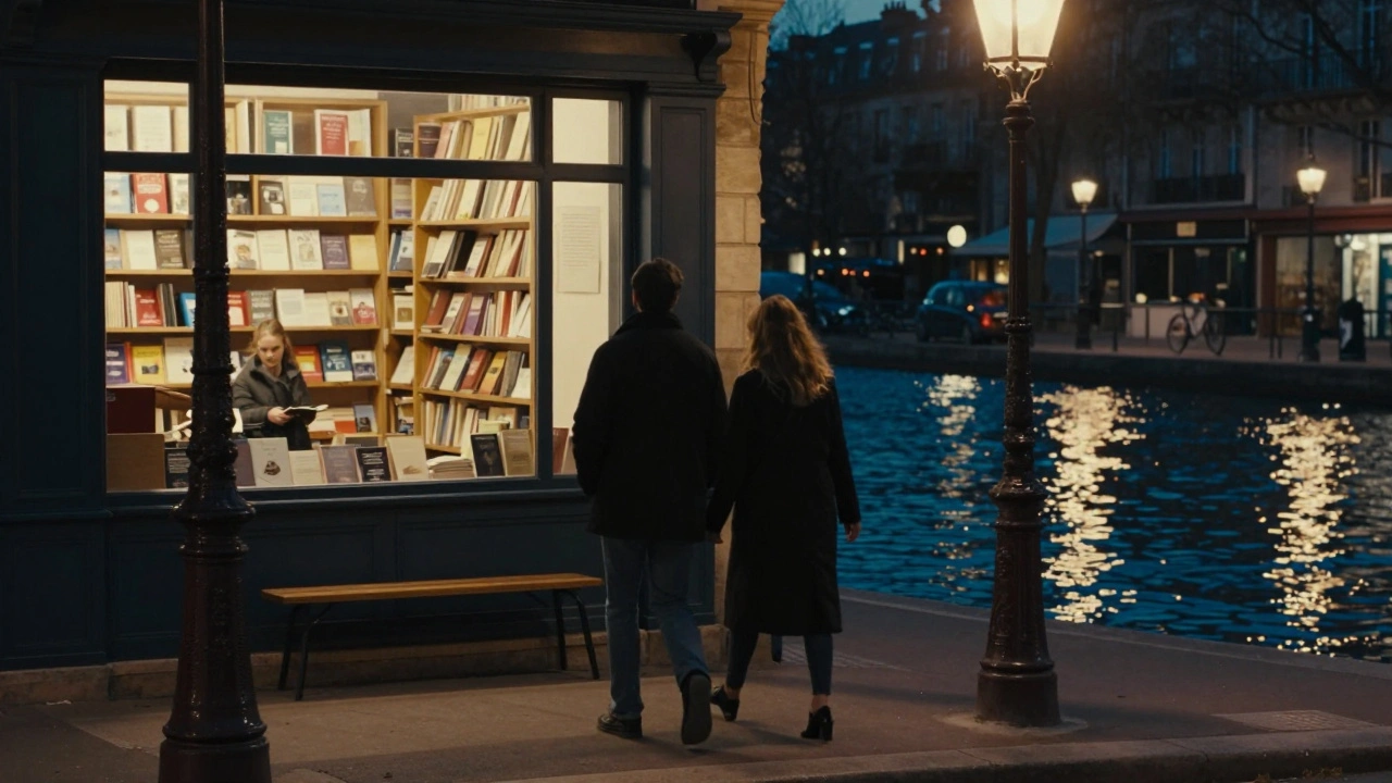 Two figures walk silently along a canal at night, lights reflecting on water.